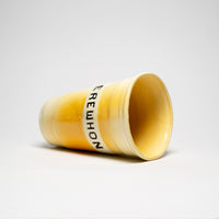 yellow cup in ceramic